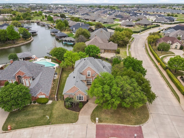 drone / aerial view with a water view and a residential view