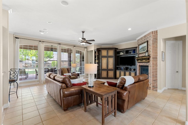 living room featuring a fireplace, crown molding, ceiling fan, and light tile patterned floors