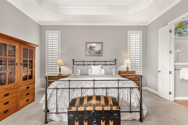 bedroom with a tray ceiling, carpet, baseboards, and ornamental molding