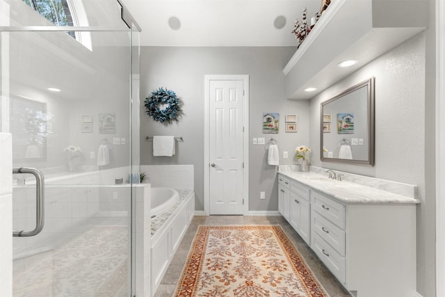 bathroom with a bath, tile patterned floors, a shower with shower door, baseboards, and vanity