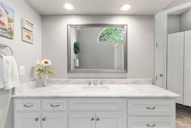 bathroom featuring vanity and recessed lighting