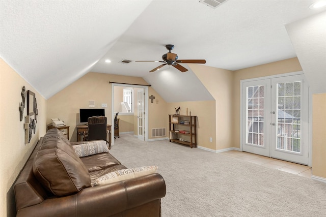 living area featuring lofted ceiling, visible vents, carpet flooring, and french doors
