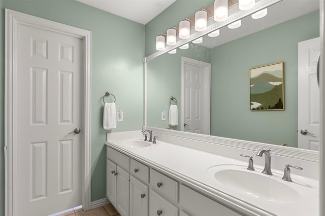 bathroom featuring double vanity, tile patterned flooring, and a sink