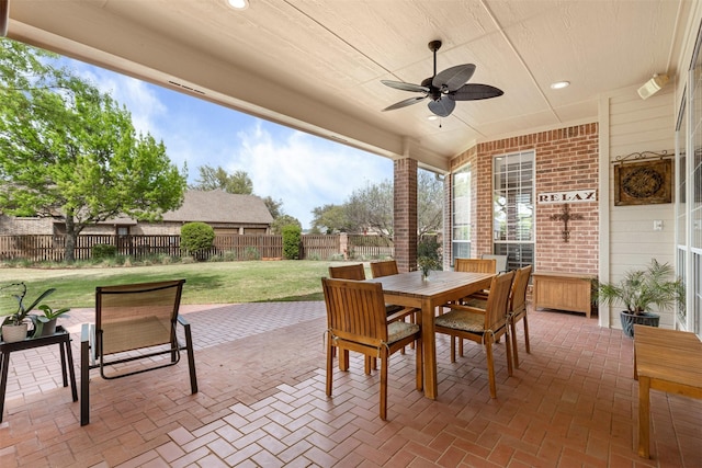 view of patio / terrace featuring a fenced backyard, ceiling fan, and outdoor dining area