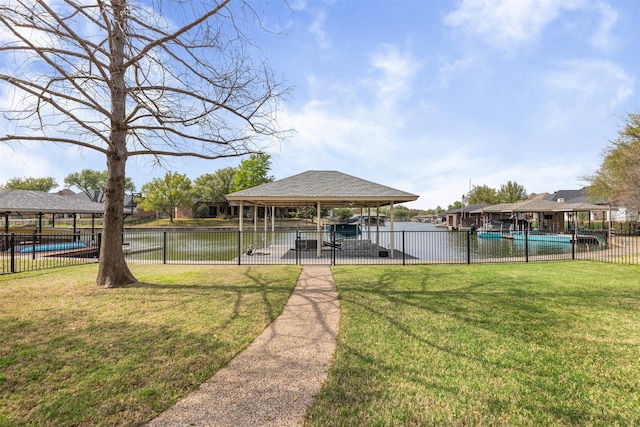 view of property's community featuring fence, a lawn, a pool, and a gazebo