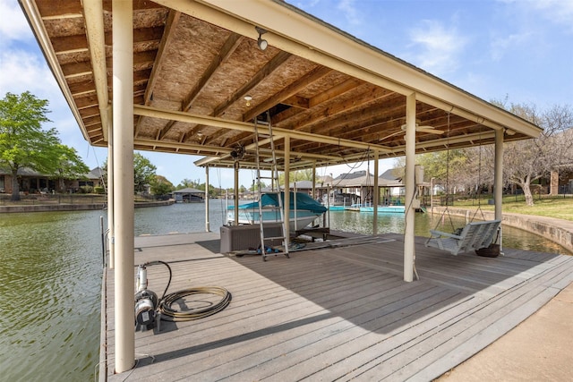 view of dock featuring boat lift and a water view