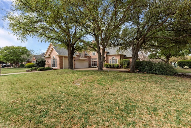 view of front of home featuring a front lawn, brick siding, and a garage
