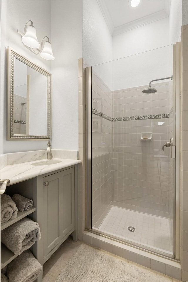 full bath with a shower stall, ornamental molding, and vanity
