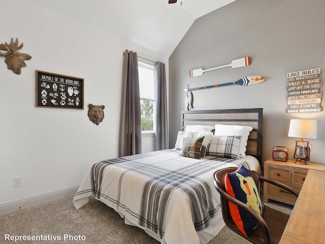 carpeted bedroom with lofted ceiling