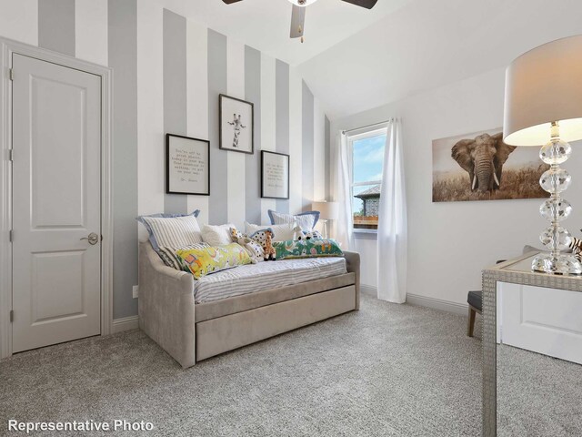 bedroom with vaulted ceiling, baseboards, carpet, and a ceiling fan