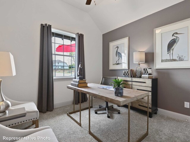 carpeted home office with vaulted ceiling, a ceiling fan, and baseboards