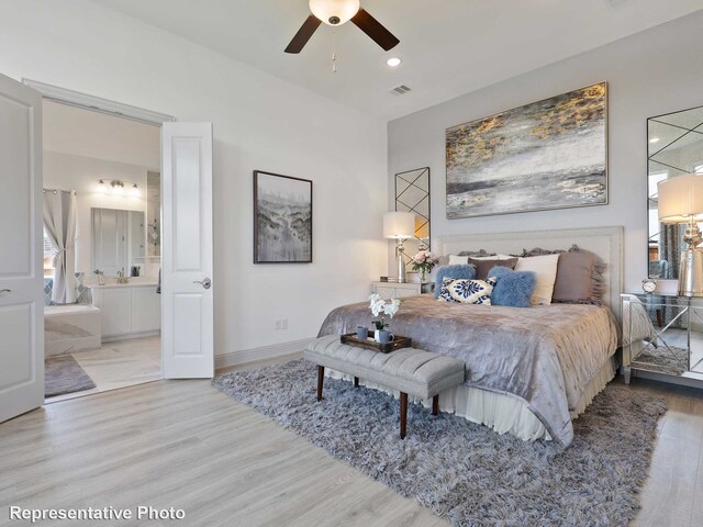 bedroom with wood finished floors, connected bathroom, baseboards, visible vents, and recessed lighting