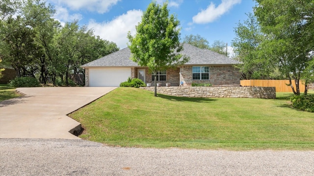 ranch-style house with concrete driveway, an attached garage, fence, and a front yard