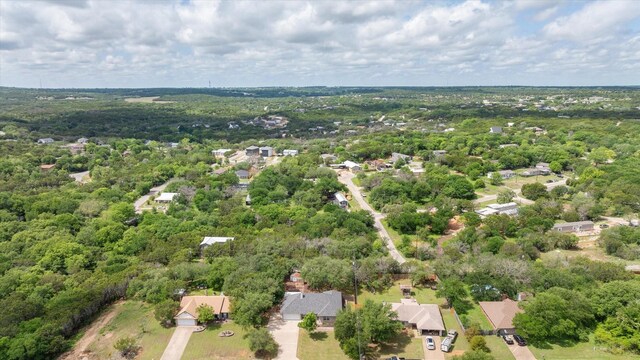drone / aerial view with a wooded view