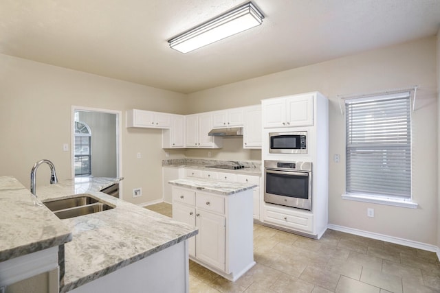 803 Sterling Ct, Allen, TX 75002 - kitchen featuring stainless steel appliances, a sink, a center island, and white cabinetry