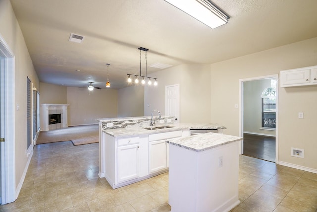 803 Sterling Ct, Allen, TX 75002 - kitchen with a sink, a center island with sink, ceiling fan, light stone counters, and open floor plan