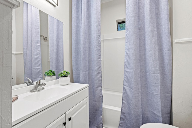 1031 W Chestnut St, Denison, TX 75020 - full bath with vanity, shower / bath combo, toilet, and a textured wall