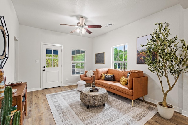 1031 W Chestnut St, Denison, TX 75020 - living area with light wood-style floors, ceiling fan, and baseboards