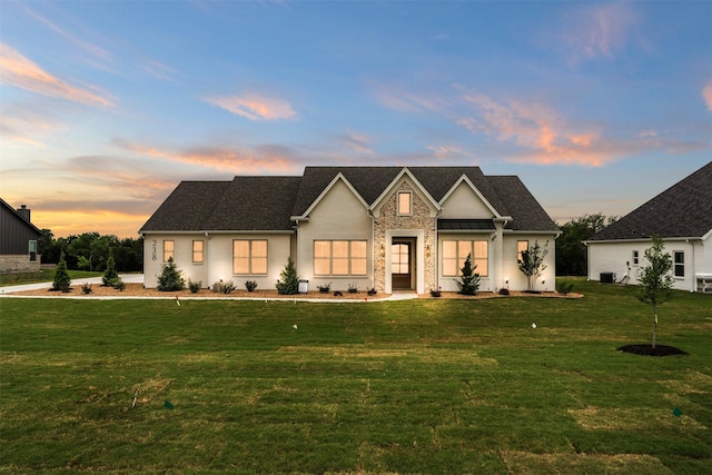 modern inspired farmhouse featuring cooling unit and a front lawn