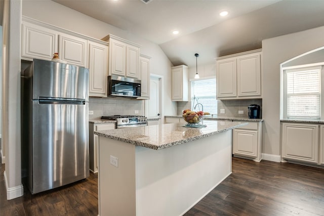 1400 Stone Ridge Dr, Anna, TX 75409 - kitchen featuring lofted ceiling, stainless steel appliances, a center island, decorative backsplash, and dark wood-style flooring