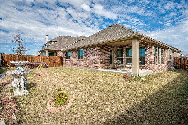 1400 Stone Ridge Dr, Anna, TX 75409 - back of property with a lawn, a shingled roof, a fenced backyard, a patio, and brick siding