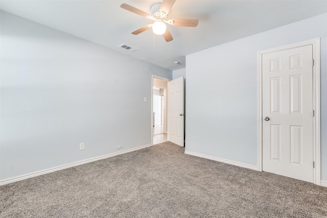 unfurnished bedroom with visible vents, carpet flooring, baseboards, and a ceiling fan