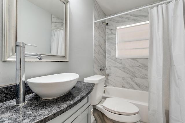 full bathroom with shower / bath combo, vanity, and toilet