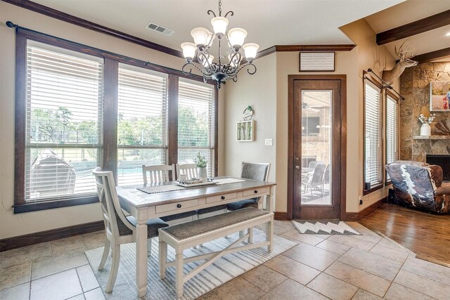 dining room with baseboards, visible vents, and plenty of natural light