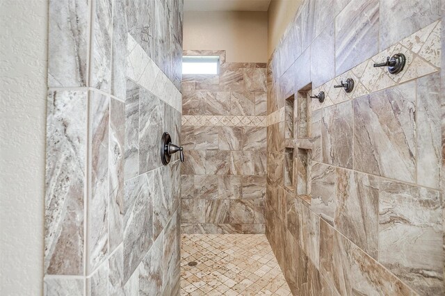 full bathroom with tiled shower