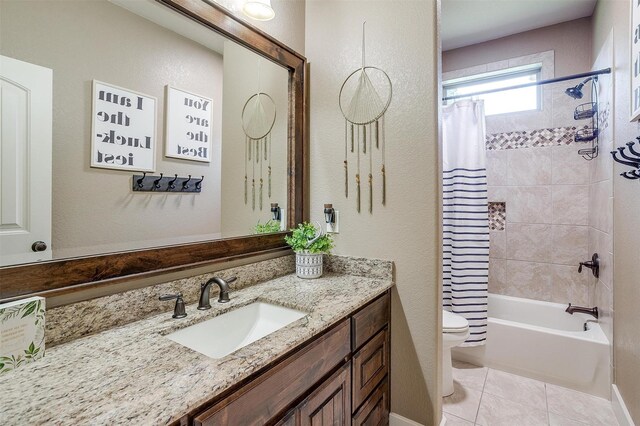 bathroom with shower / bath combination with curtain, tile patterned floors, vanity, and toilet