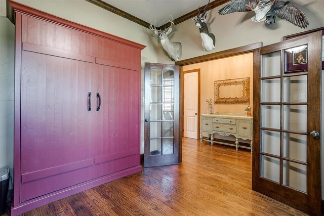 interior space featuring ornamental molding, french doors, and wood finished floors