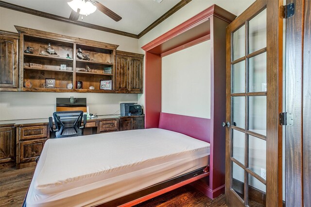 bedroom with ornamental molding, dark wood-type flooring, and built in desk
