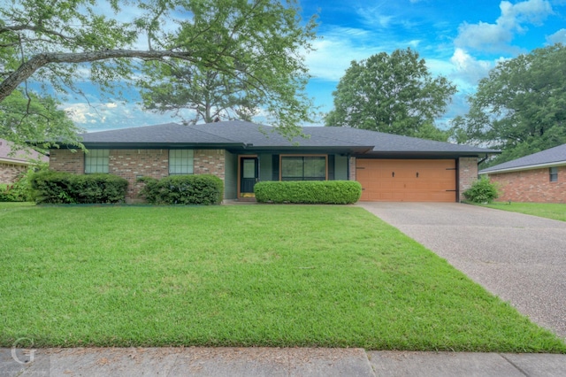 ranch-style home with concrete driveway, an attached garage, brick siding, and a front yard