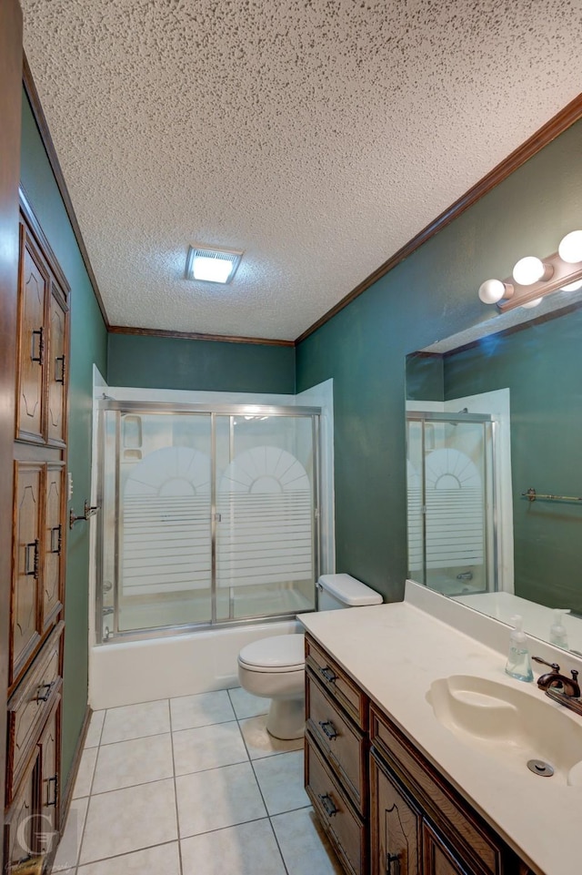 bathroom with vanity, enclosed tub / shower combo, crown molding, and tile patterned flooring