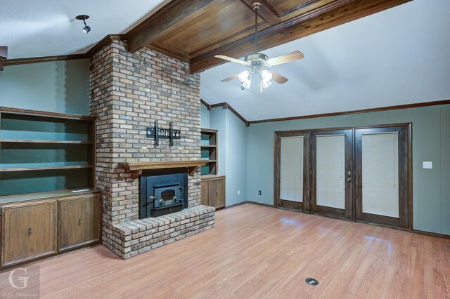 unfurnished living room with lofted ceiling with beams, light wood-style floors, ceiling fan, baseboards, and ornamental molding
