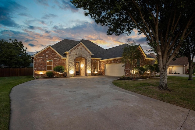 1027 Addison Ave, Pottsboro, TX 75076 - french country style house with concrete driveway, a garage, brick siding, and stone siding