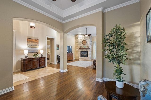1027 Addison Ave, Pottsboro, TX 75076 - entrance foyer with ceiling fan, wood finished floors, a stone fireplace, and ornamental molding