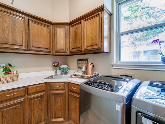 laundry area featuring cabinet space and washer and clothes dryer