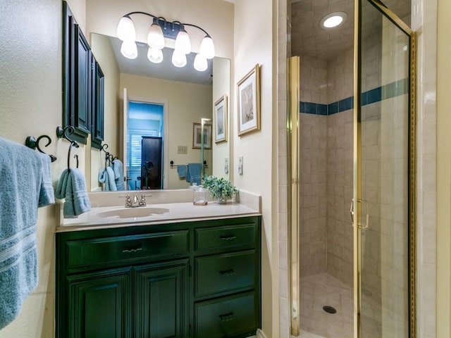 bathroom featuring vanity and a shower stall