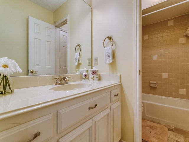 bathroom featuring bathtub / shower combination and vanity