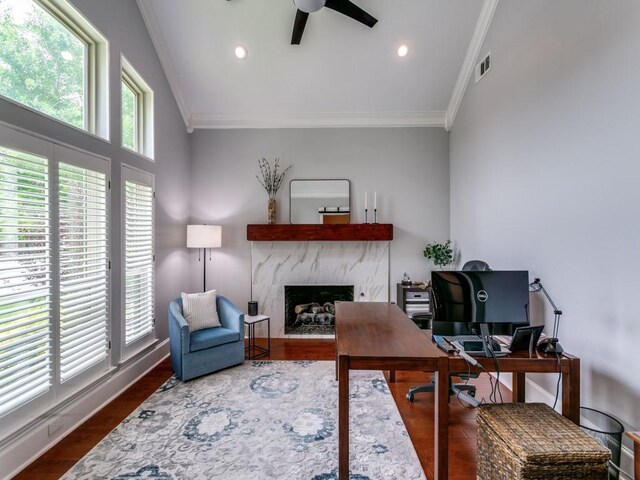 home office with ceiling fan, visible vents, ornamental molding, and a fireplace