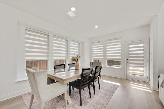 dining room featuring light wood-type flooring, baseboards, and recessed lighting