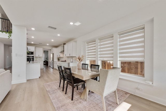 dining room with recessed lighting, baseboards, visible vents, and light wood-type flooring