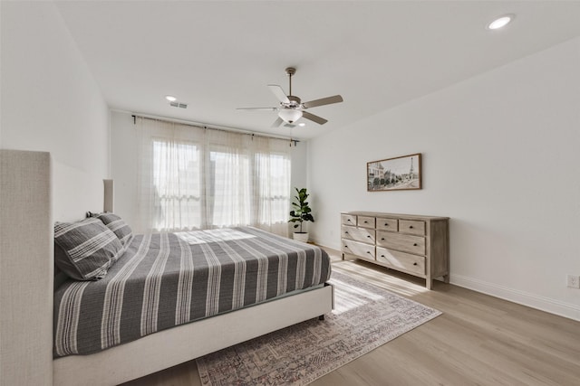 bedroom with wood finished floors, ceiling fan, baseboards, visible vents, and recessed lighting