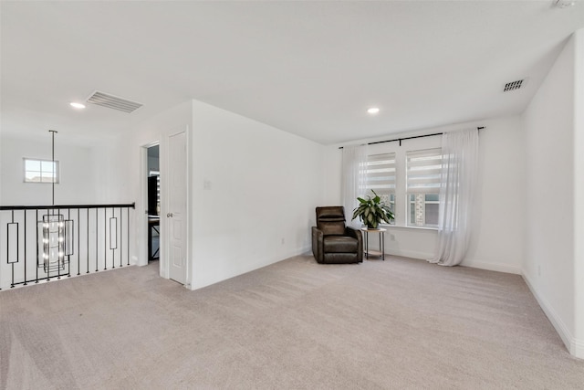 living area with visible vents and carpet floors