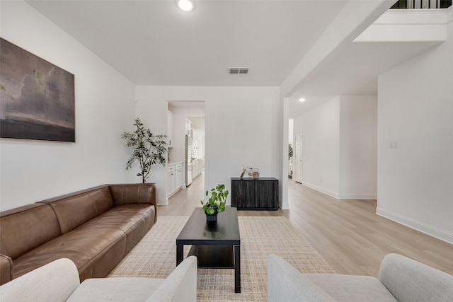 living area featuring baseboards, visible vents, recessed lighting, and light wood-style floors