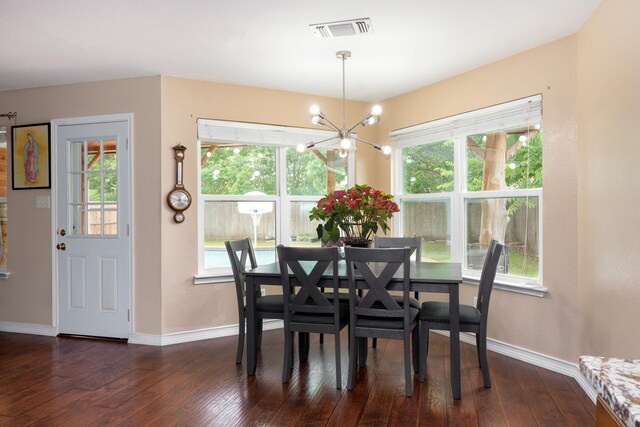 dining space featuring baseboards, dark wood-style floors, a chandelier, and visible vents
