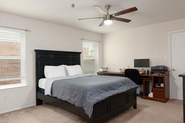 bedroom with light colored carpet and a ceiling fan