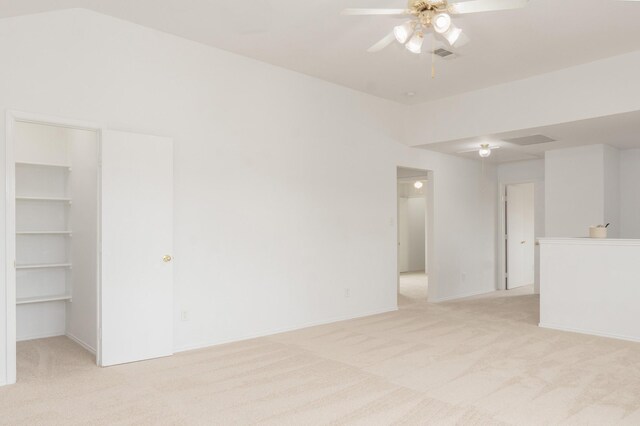 unfurnished room with visible vents, a ceiling fan, and light colored carpet