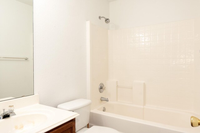 bathroom featuring toilet, shower / washtub combination, and vanity